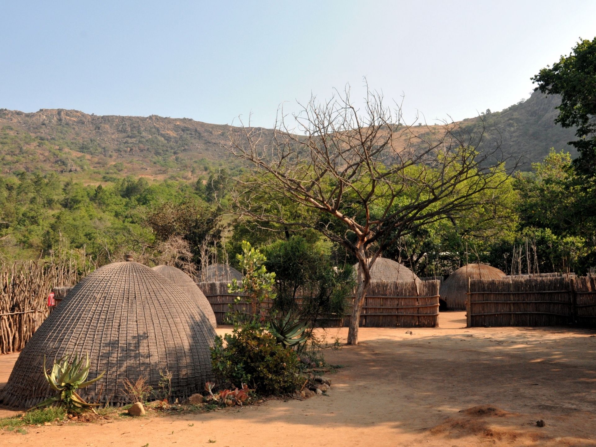 Rolling hills and traditional homestead scene in Swaziland Eswatini
